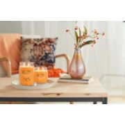 two Signature Jar candles on table with vase image number 3
