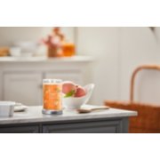 farm fresh peach signature large tumbler candle on kitchen counter image number 3
