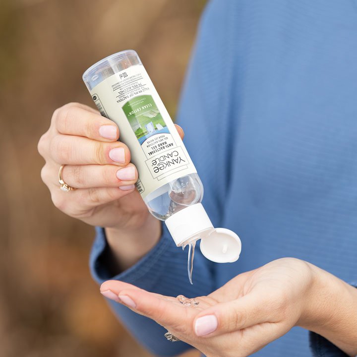 clean cotton gel hand sanitizer being poured into hand