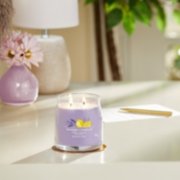 lemon lavender signature medium jar candle on table in living room image number 2
