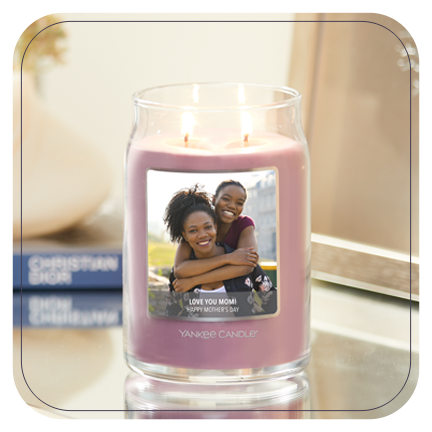 a pink-colored signature large jar candle with a personalized photo label of two women and a message reading l love you mom happy mother's day