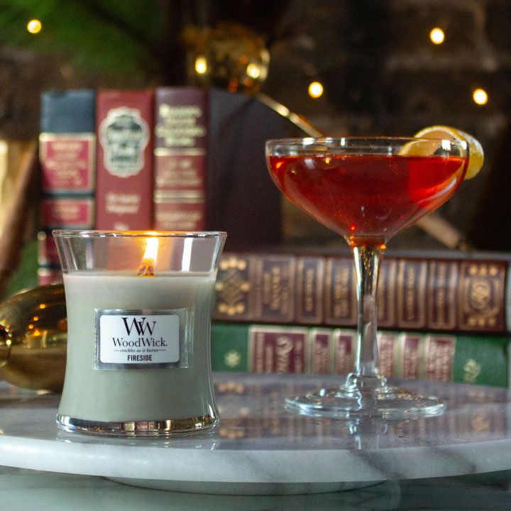 fireside scented candle next to manhattan cocktail
