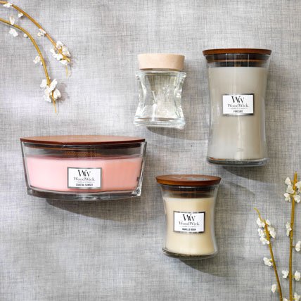 three woodwick candles and one spill-proof fragrance diffuser in various scents and sizes