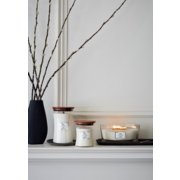 three woodwick linen candles in various sizes on mantle image number 2