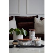 three woodwick warm wool candles in various sizes on living room table image number 3