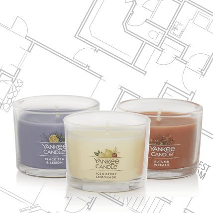 three yankee candle minis on house blueprint