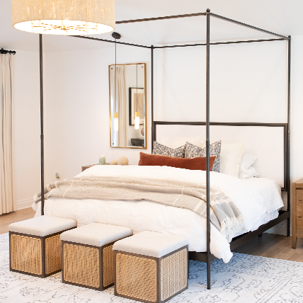 bedroom with three square chairs and a large jar candle burning in background