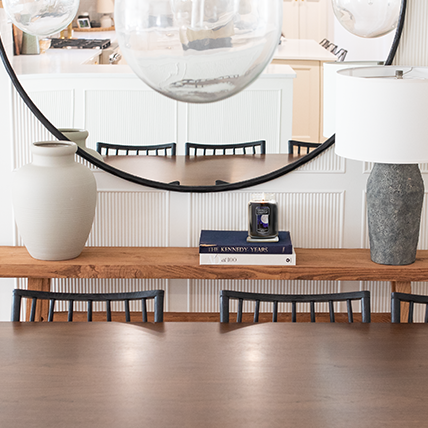 original large jar candle burning on coaster on stack of books in dining room table scene