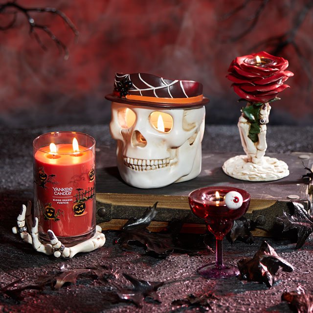 four phantasmagoria candle holders with skeleton hands skull and eyeball with black leaves and branches