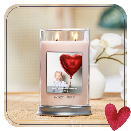 a signature large tumbler candle with a valentine's day personalized photo label on a table