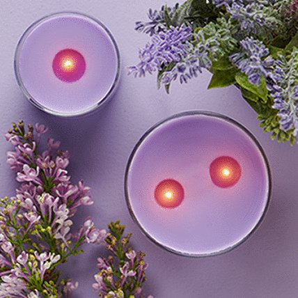 candle with decorative purple flowers