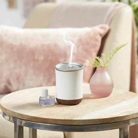 The Serene Air portable diffuser on a table in a living room