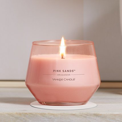 pink sands studio collection candle on a table