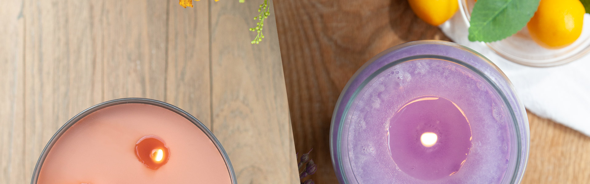 top view of lit pink and purple candles on wood tables